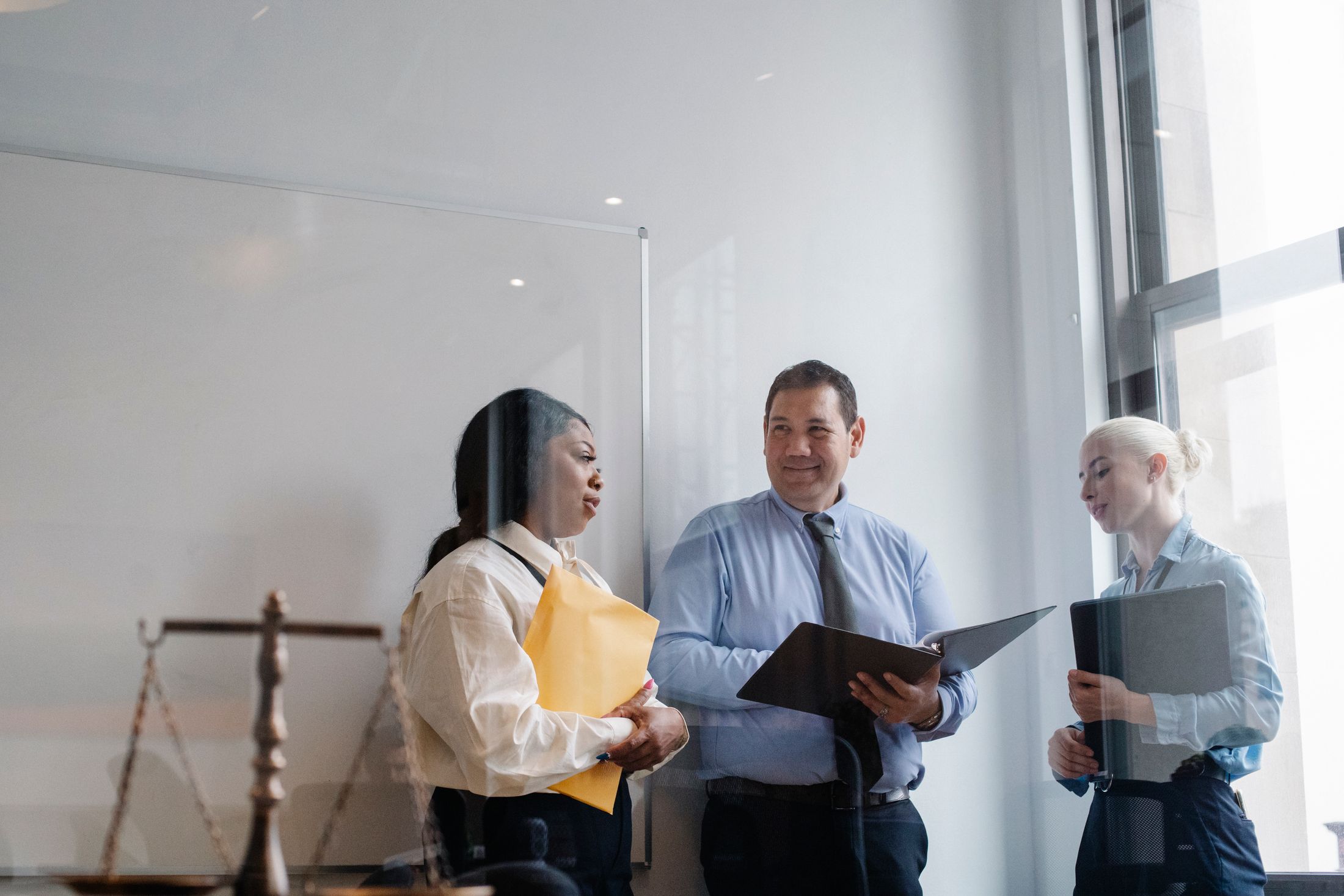 Legal professionals discussing work in an office
